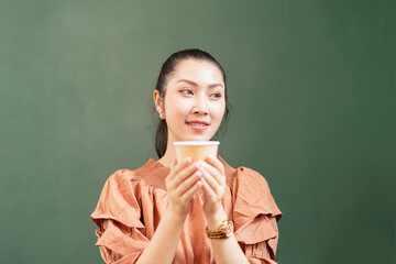 Right side of beautiful Asian woman customer happy to drink coffee and looks at left side in coffee bar