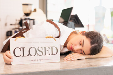 Right side of beautiful caucasian barista woman relax sleeping with show closed shop signs on coffee bar