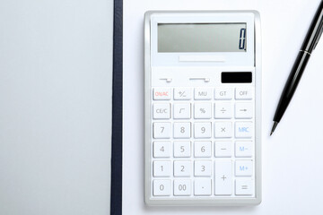 Calculator, clipboard and pen on white background, top view. Space for text