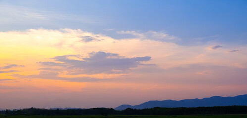 Colorful sunset and sunrise with clouds. Blue and orange color of nature. Many white clouds in the blue sky. The weather is clear today. sunset in the clouds. The sky is twilight.