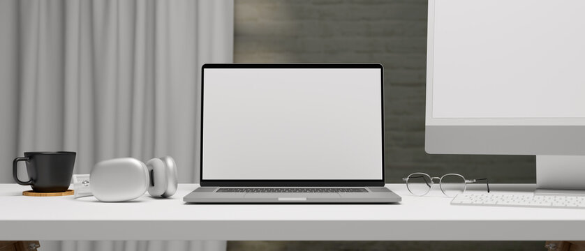 Laptop with mock-up screen on computer desk with accessories and supplies, 3D rendering