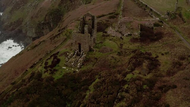 Close-up aerial orbit of the National Trusts' remains of the tin mine building Cornwall, England, part of the moody scenery used in the Masterpiece Theater presentation of Poldark.