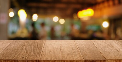 Empty wooden table in front of abstract blurred background of coffee shop . can be used for display or montage your products.Mock up for display of product.