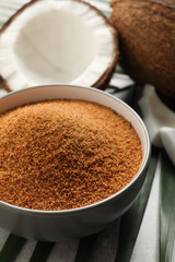 Natural coconut sugar in bowl on table