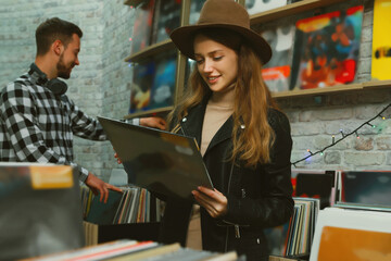 Young woman with vinyl records in store