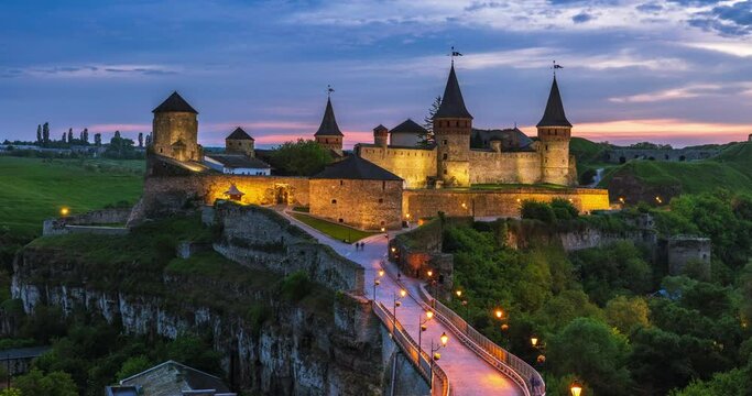 Time lapse of Sunset over the city of Kamianets-Podilskyi. Kamianets-Podilskyi Castle is the fortress located in the histori