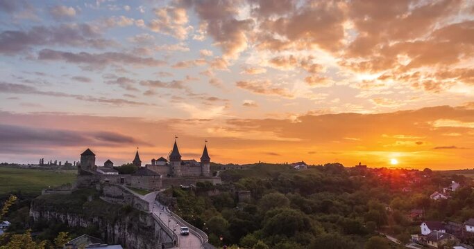 Time lapse of Sunset over the city of Kamianets-Podilskyi. Kamianets-Podilskyi Castle is the fortress located in the histori