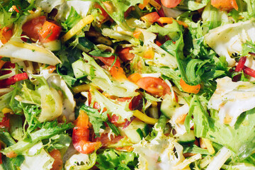 Healthy green salad background. Fit dinner texture. Raw vegetables mix. Closeup salad in bowl. Summer lunch background.