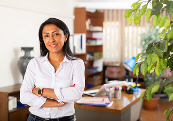 Portrait of friendly businesswoman in modern office