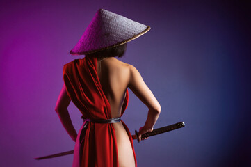 nude slender Asian woman in a red cape and an Asian hat with a katana in her hand image of a...