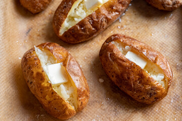 Hot buttered jacket baked potatoes close up