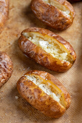 Hot buttered jacket baked potatoes close up