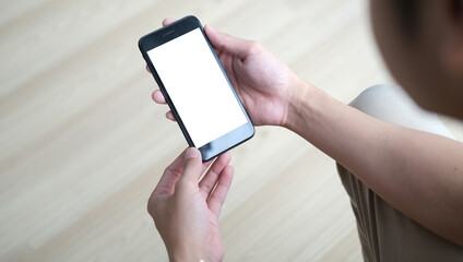 Cropped shot view of man hands holding smart phone with blank copy space screen for your text message or information content, female reading text message on cell telephone during in urban setting.	
