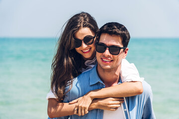 Vacation romantic lovers young happy couple hug and standing on sand at sea having fun and relaxing together on tropical beach.Summer travel