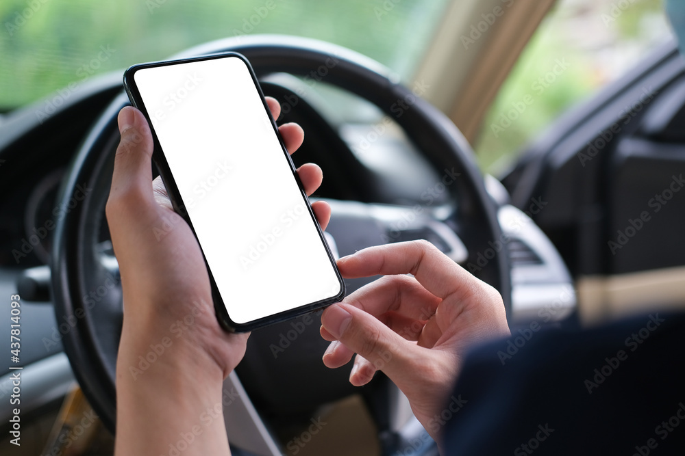 Poster cropped shot view the driver uses the phone while driving. modern smart phone with round edges. isol