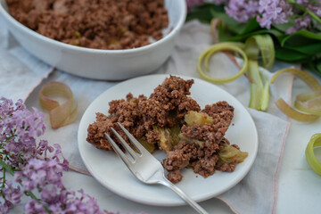 sweet home made chocolate rhubarb crumble with lilach flowers