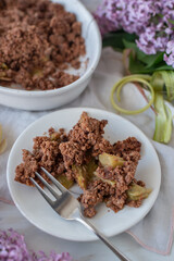 sweet home made chocolate rhubarb crumble with lilach flowers
