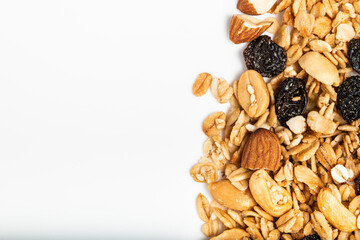 Granola with dried fruits on white background. Top view. Macro photography.