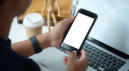 Close up view of businessman holding mock up smart phone with blank screen.	