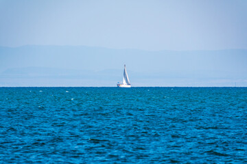 Fototapeta premium Sailing yacht in the blue calm sea.