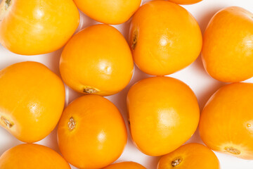 Background texture of several Cape Gooseberries, or goldenberries. Top view. White background.