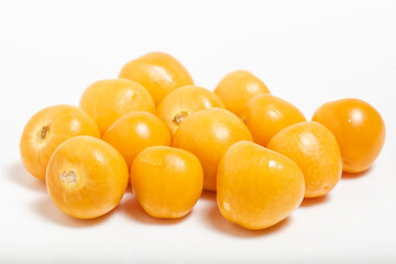 Bunch of bright yellow ripe Cape goldenberries isolated on white background. Macro photography.