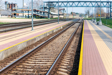 Fototapeta na wymiar Railroad tracks urban shoot. Leading line view.iron rusty train railway over dark stones rail way