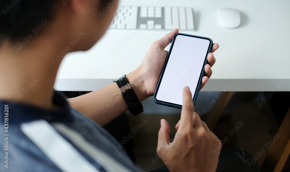 Poster close up view of businessman holding mock up smart phone with blank screen.