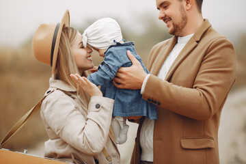 Stylish family walking on a autumn field