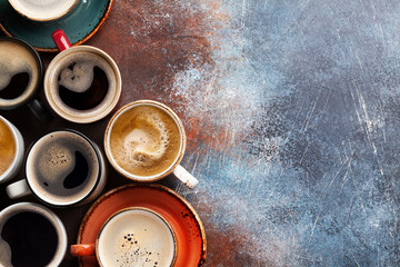Many cups of coffee on stone table