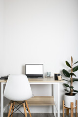 Empty on people. white bedroom with desk office space interior design With Mockup laptop supplies white screen tables and chairs and white walls. vertical