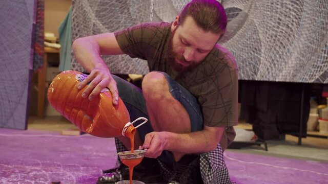 A talented painter is filtering paints 