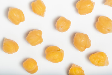 Cooked chickpeas pattern on white background. Top view. Macro photography.