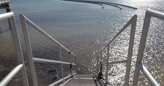 Walking down stairs to the water at a swimming area in Wallaroo South Austrlai