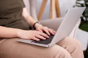 close up of female hands on laptop keyboard