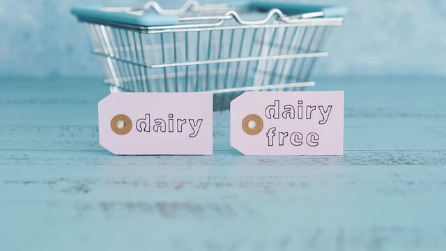 dairy vs dairy-free product tags with shopping basket, plant-based food or allergies and nutritional choices