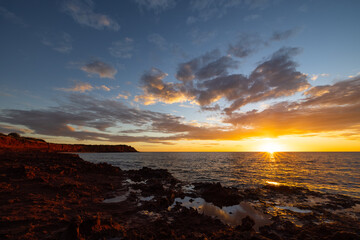 Silhouette of canon camera and tripod taking pictures of sunset at Cape Peron National Park, Western Australia