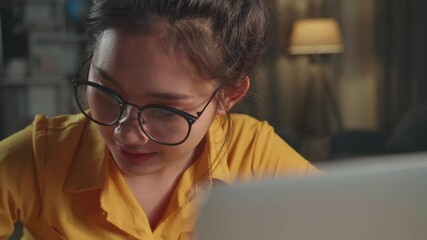 Close Up Asia Girl Learning Online Or Working From Laptop At Night
