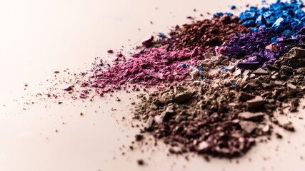 broken eye shadow scattered across the smooth pink surface. Texture background, advertising the structure of cosmetics. macro, copyspace