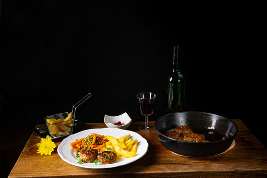 Homemade meatballs with french fries and vegetables