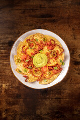 Nachos, top shot on a rustic wooden background with copyspace