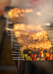 Cooking meat on open fire. Meat and vegetable national traditional dishes.