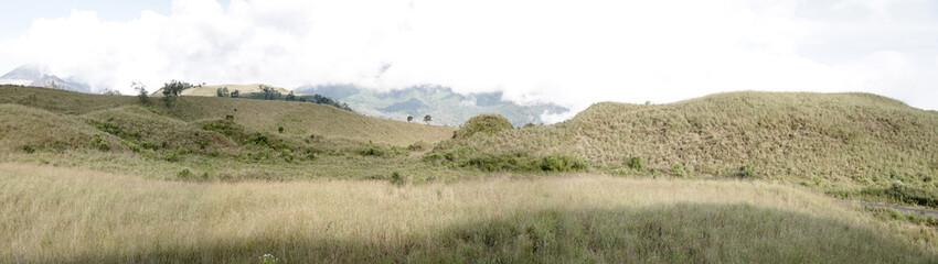 Obraz premium Crater hill of Kawah Wurung on the top of Mount Ijen and Mount Merapi at Bondowoso, Indonesia. Natural landscape background. 