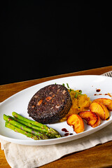 Black pudding with green asparagus and fried apple