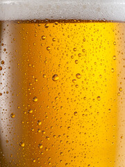 Cooled glass of beer close-up. Small water drops on cold surface of beer glass.