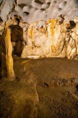 Inside view of Karain Cave in Antalya, with natural stalactites and stalagmites around in Turkey