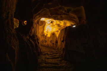 Fototapeta premium Inside view of Karain Cave in Antalya, with natural stalactites and stalagmites around in Turkey