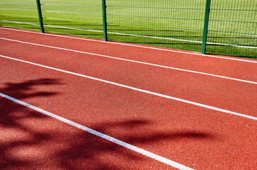 Red treadmill on sport field. Running track on the stadium