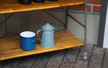 Blue cups and pots on the shelf in the room