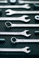 Fototapeta premium Set of chrome wrenches on steel surface. Mechanic tools for maintenance. Hardware tools to fix